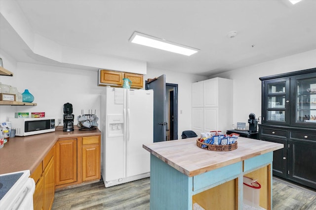 kitchen featuring butcher block countertops, white appliances, open shelves, light wood-style flooring, and a kitchen island