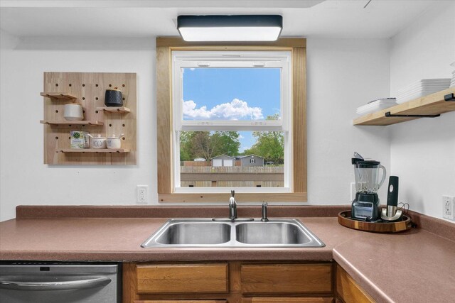 kitchen featuring open shelves, dishwasher, brown cabinets, and a sink