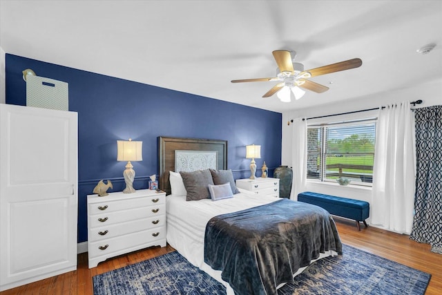 bedroom featuring a ceiling fan and wood finished floors