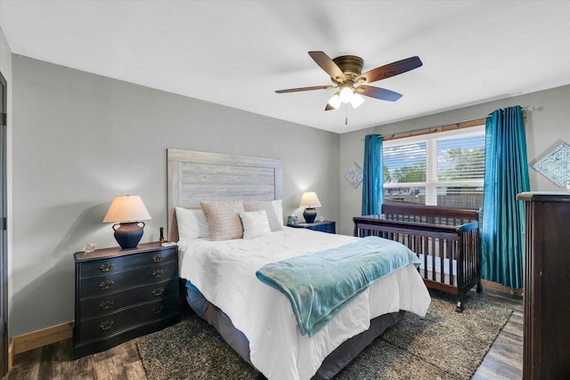 bedroom with ceiling fan, baseboards, and wood finished floors