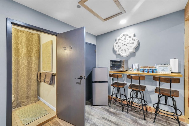 interior space with attic access, a toaster, wood finished floors, and recessed lighting