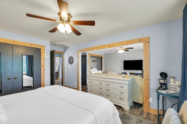 bedroom featuring ceiling fan, baseboards, and wood finished floors