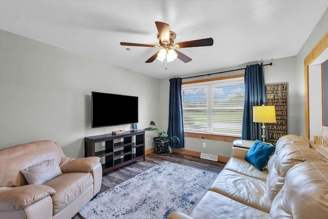 living room with baseboards, ceiling fan, visible vents, and wood finished floors