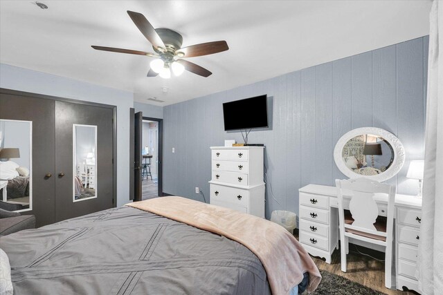 bedroom with french doors, wood finished floors, and a ceiling fan