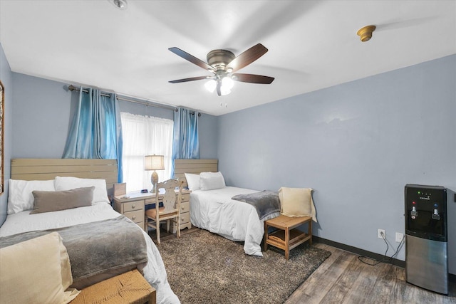 bedroom featuring a ceiling fan, baseboards, and wood finished floors