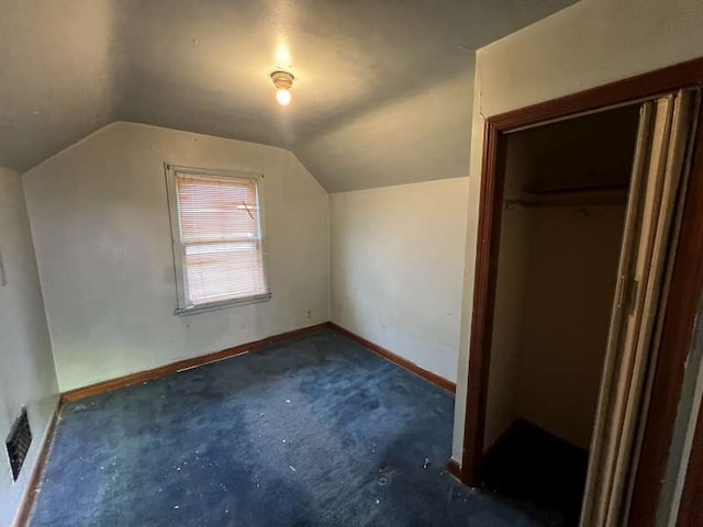 bonus room with vaulted ceiling, baseboards, and carpet flooring