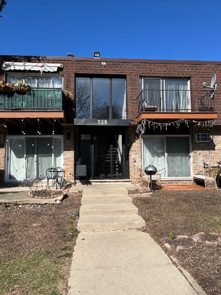 725 Grove Dr Unit 209, Buffalo Grove, IL 60089 - view of front facade with brick siding and a balcony