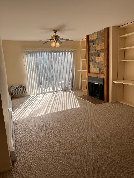 725 Grove Dr Unit 209, Buffalo Grove, IL 60089 - living area with a fireplace, carpet, and a ceiling fan