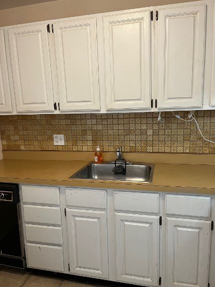 725 Grove Dr Unit 209, Buffalo Grove, IL 60089 - kitchen featuring white cabinets, black dishwasher, and a sink