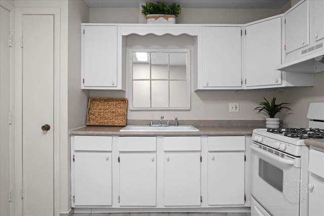 1313A S Rebecca Rd Unit 202, Lombard, IL 60148 - kitchen featuring white gas range, under cabinet range hood, a sink, and white cabinetry