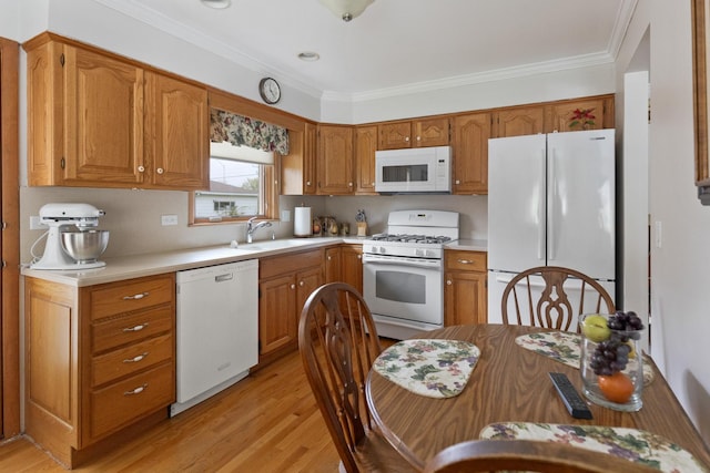 437 Wingate Dr, Schaumburg, IL 60193 - kitchen with white appliances, a sink, light wood-style floors, light countertops, and ornamental molding