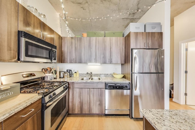 235 W Van Buren St Unit 3414, Chicago, IL 60607 - kitchen with appliances with stainless steel finishes, a sink, light wood-type flooring, and light stone counters