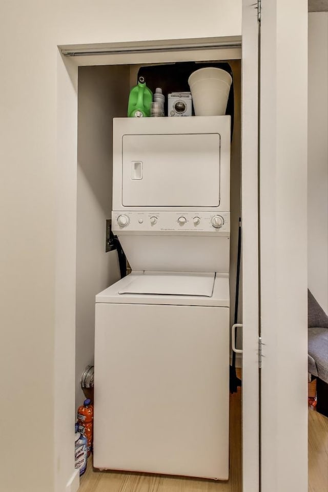235 W Van Buren St Unit 3414, Chicago, IL 60607 - clothes washing area with estacked washer and dryer and light wood finished floors