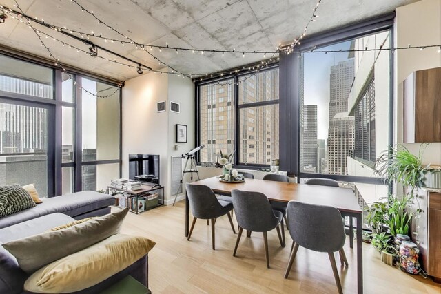 235 W Van Buren St Unit 3414, Chicago, IL 60607 - dining room featuring expansive windows, wood finished floors, and track lighting