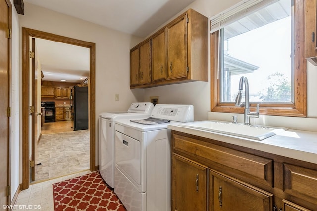 laundry area featuring separate washer and dryer and cabinet space