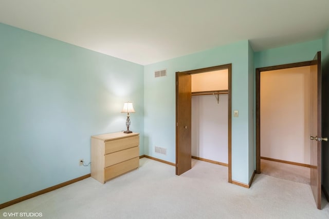 unfurnished bedroom with light carpet, baseboards, and a closet