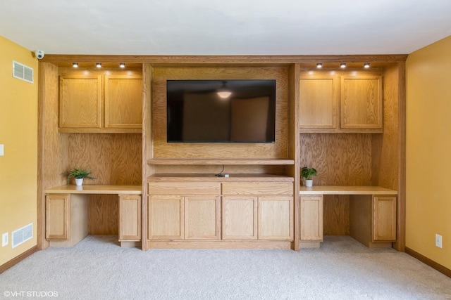 unfurnished living room with light colored carpet and baseboards