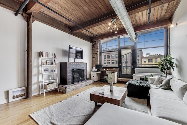 1000 W Washington Blvd Unit 342, Chicago, IL 60607 - living area with wood ceiling, beamed ceiling, a fireplace with raised hearth, and wood finished floors