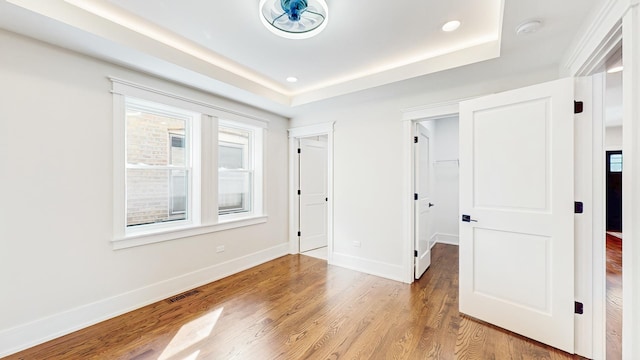unfurnished room with recessed lighting, baseboards, visible vents, and wood finished floors