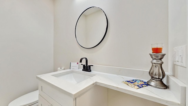 bathroom with toilet and vanity