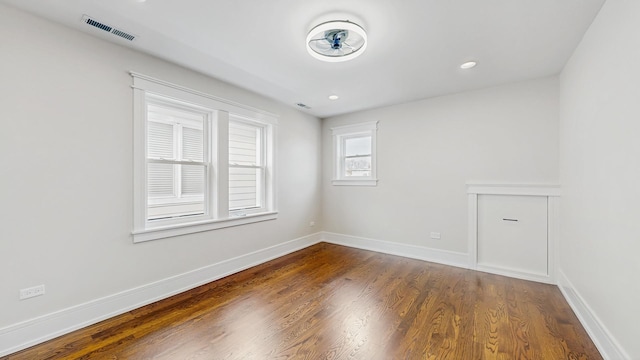 unfurnished room with recessed lighting, baseboards, visible vents, and wood finished floors