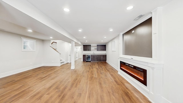 unfurnished living room with visible vents, baseboards, light wood-style flooring, and recessed lighting