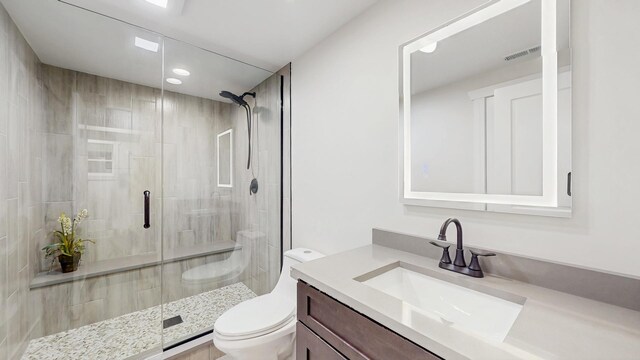 full bath featuring toilet, a stall shower, visible vents, vanity, and recessed lighting