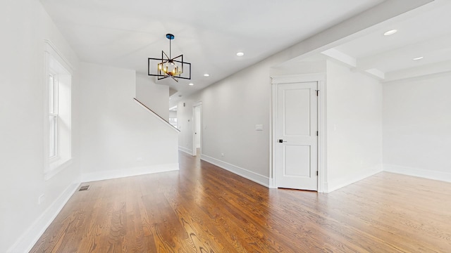 interior space featuring stairway, a chandelier, recessed lighting, and wood finished floors