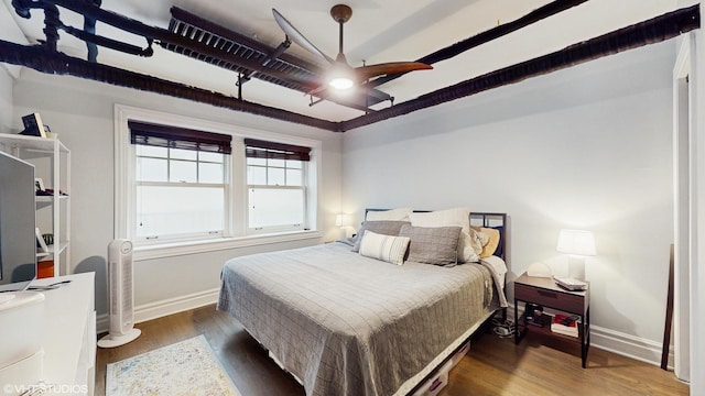bedroom featuring baseboards and wood finished floors