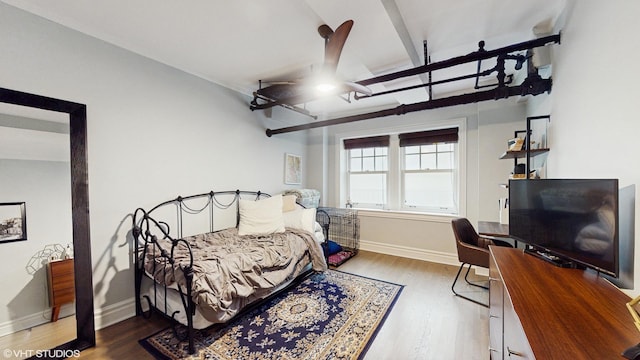 bedroom with baseboards and wood finished floors