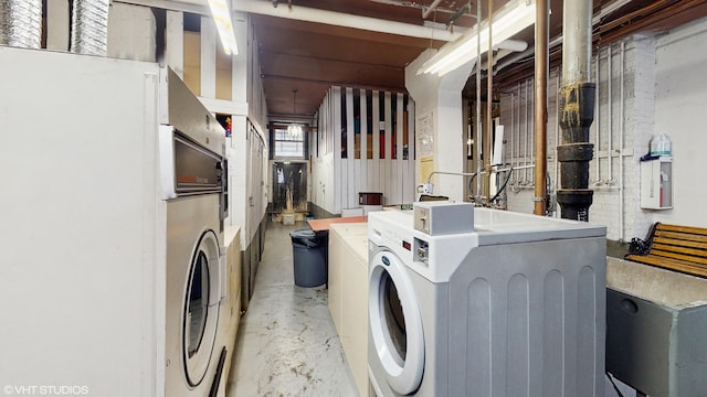 laundry room featuring washing machine and clothes dryer