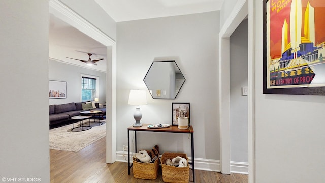 hall with wood finished floors and baseboards