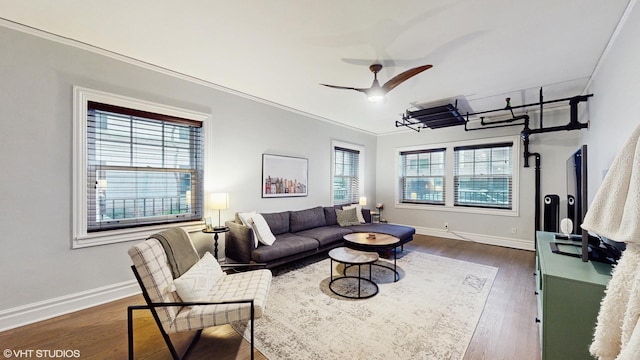 living room with baseboards, plenty of natural light, and dark wood finished floors