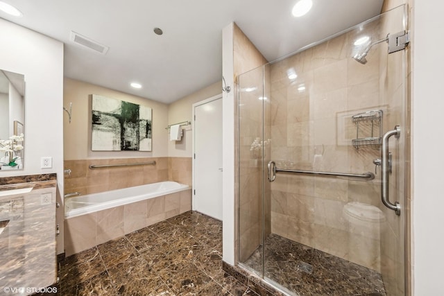 bathroom with recessed lighting, visible vents, a shower stall, a garden tub, and vanity