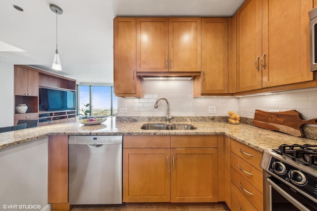 kitchen with a sink, stainless steel appliances, brown cabinets, backsplash, and light stone countertops