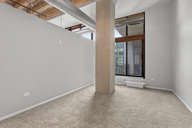 spare room with carpet flooring and baseboards