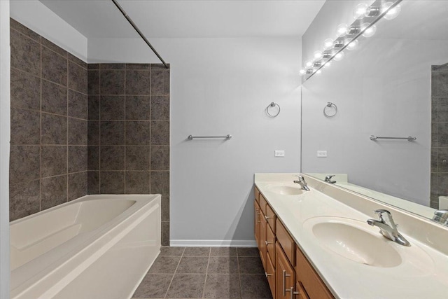 full bath with baseboards, tile patterned floors, and double vanity