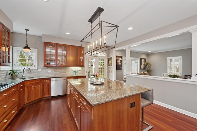 kitchen featuring stainless steel dishwasher, a sink, dark wood-style flooring, brown cabinets, and recessed lighting