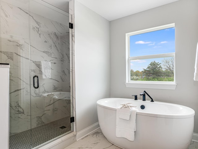 full bath featuring a freestanding tub, baseboards, a marble finish shower, and marble finish floor