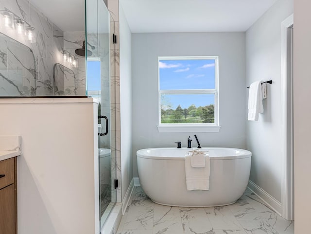 bathroom with a stall shower, vanity, baseboards, marble finish floor, and a soaking tub