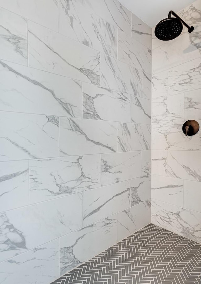 bathroom with a tile shower
