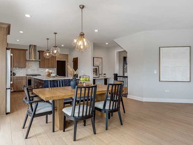 dining space featuring baseboards, recessed lighting, light wood-style flooring, and a notable chandelier