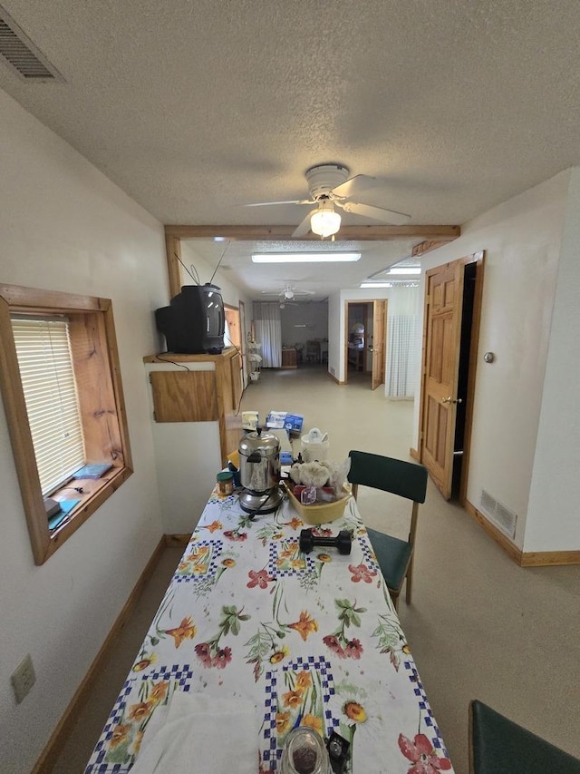 dining space with visible vents and a textured ceiling
