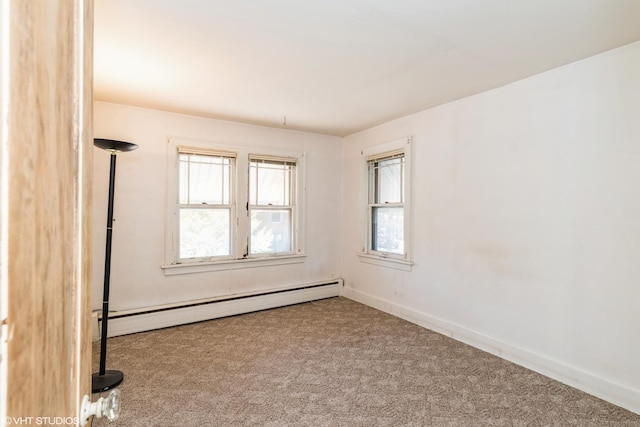 carpeted empty room featuring a baseboard radiator and baseboards