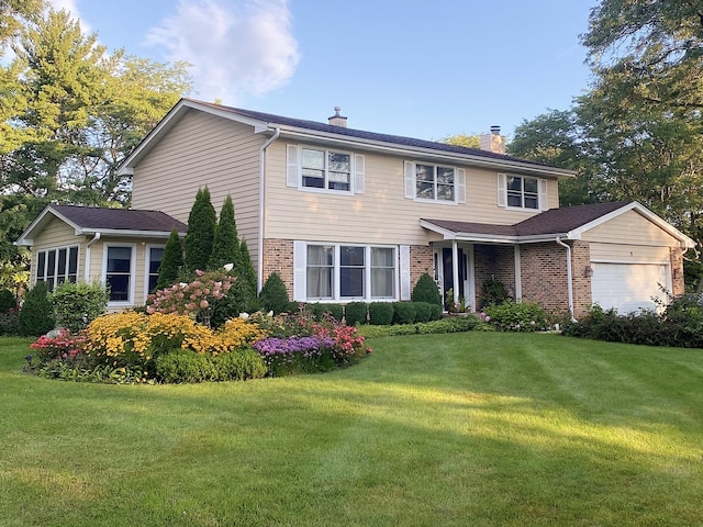9 Aberdeen Rd, Hawthorn Woods, IL 60047 - view of front of house featuring a front lawn, brick siding, a chimney, and a garage
