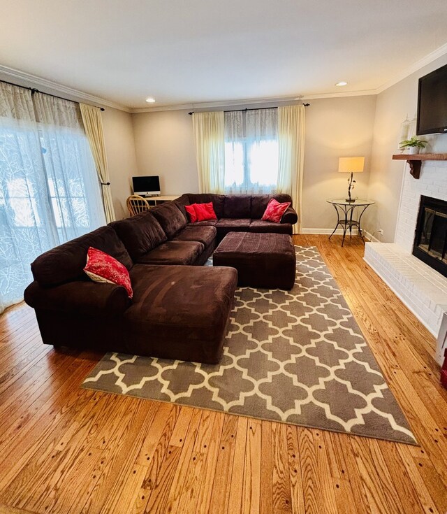 9 Aberdeen Rd, Hawthorn Woods, IL 60047 - living area with wood finished floors, ornamental molding, recessed lighting, a brick fireplace, and baseboards