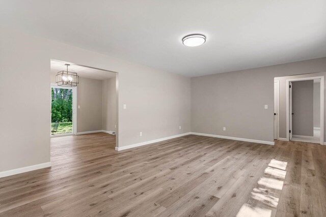 2705 Arlene Dr, Urbana, IL 61802 - empty room with light wood-type flooring, baseboards, and a chandelier