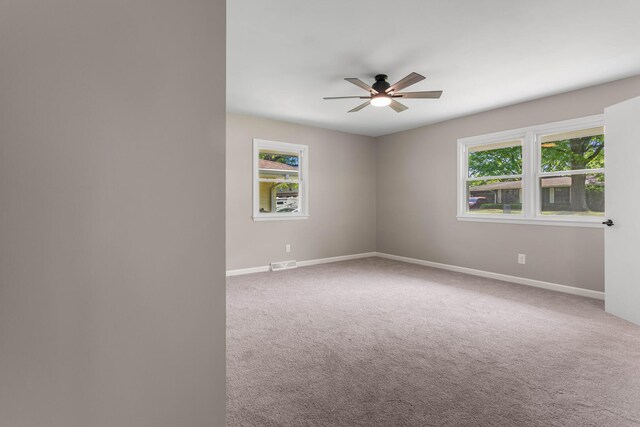 2705 Arlene Dr, Urbana, IL 61802 - carpeted empty room featuring ceiling fan, baseboards, and plenty of natural light
