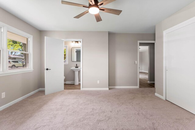 2705 Arlene Dr, Urbana, IL 61802 - unfurnished bedroom with carpet flooring, a sink, baseboards, ensuite bath, and a ceiling fan