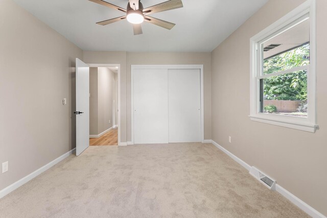 2705 Arlene Dr, Urbana, IL 61802 - unfurnished bedroom featuring light carpet, a closet, and baseboards